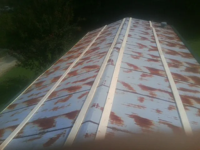 Rusted metal roof panels with new wood purlins before replacement — Storm Damage Roof Repair in Port Richey by Roofing Brothers